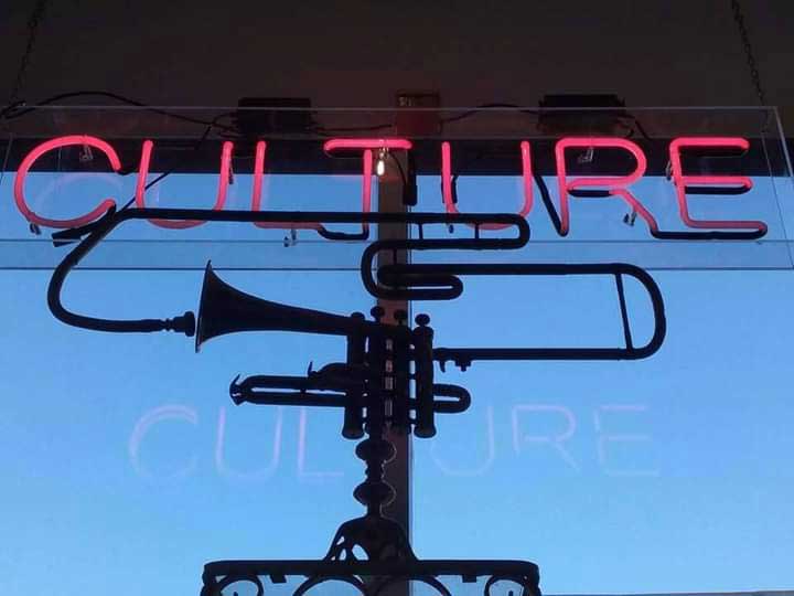 gnarly trumpet art with neon sign